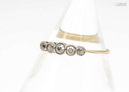 An 18ct gold platinum and diamond five stone ring, the old cut diamonds in millegrain setting,