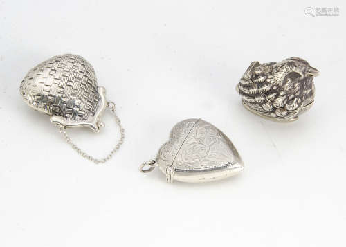 Two small white metal cases, one modelled as a chick, 40mm, the other as a purse, 47mm, together