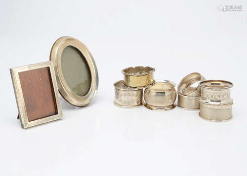 Seven various silver napkin rings, together with two small silver mounted photograph frames (9)