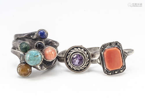 Three contemporary silver rings, including a multi gem set example set with cabochon turquoise,