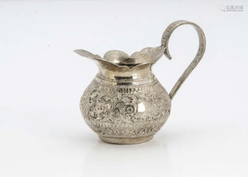 A small Middle Eastern white metal jug, probably c1900 from Burma, dented, 2.9 ozt, 8.5cm high