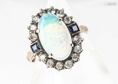 An opal and paste set dress ring, in white and gilt metal, the cluster mount with central oval