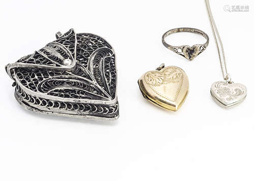 A collection of heart shaped jewellery, including a white metal filigree purse, a silver heart