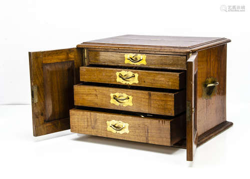 A Victorian walnut cutlery box, with a pair of hinged front doors opening to reveal four graduated