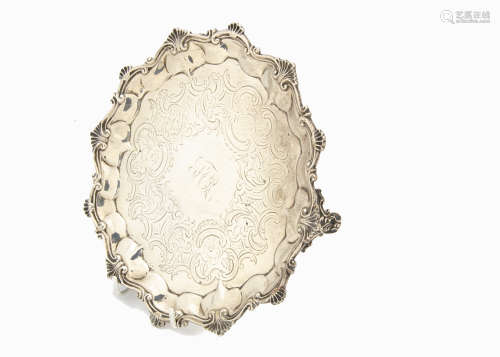 An early Victorian silver salver by DH CH, shaped rim with shells, engraved to well, on three