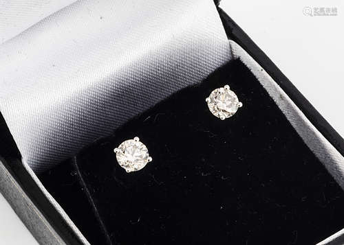 A pair of brilliant cut diamond ear studs, in 18ct white gold claw settings, total diamond weight