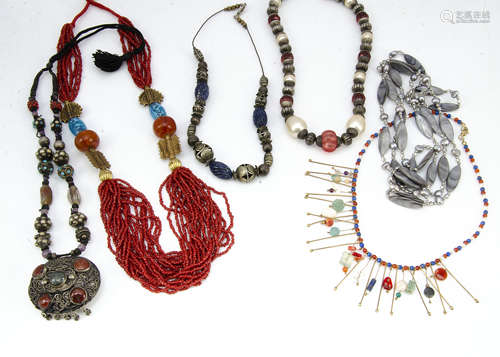 A collection of North African and Middle Eastern bead jewellery, set with cornelian, lapis lazuli,