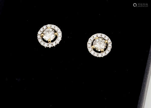 A pair of contemporary diamond ear studs, brilliant cuts in halo bezels, diamonds 0.66ct