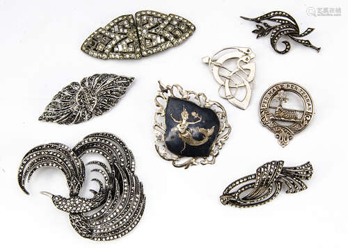 A collection of silver and white metal marcasite and paste brooches, including a double clip