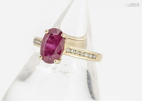 A ruby and diamond 18ct gold dress ring, with oval mixed cut claw set ruby, with brilliant cut