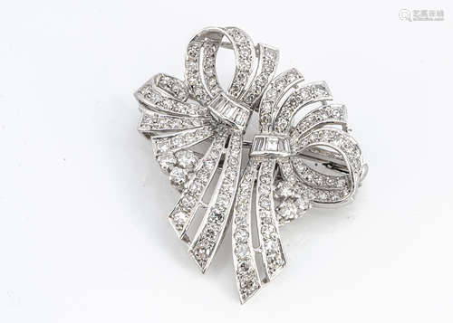 An Art Deco diamond and platinum double clip bow brooch, set mostly with eight cut diamonds and