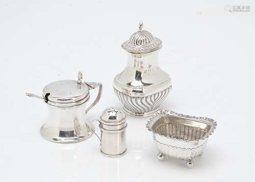 An Edwardian silver capstan mustard, together with a spoon, a silver pepper, a smaller silver