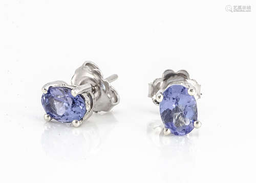 A pair of oval mixed cut tanzanite ear studs set in silver