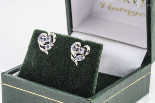 A pair of 9ct gold tanzanite and diamond stud earrings, in heart shaped settings, boxed
