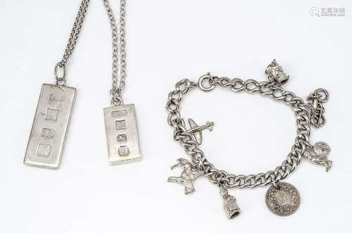 A collection of silver jewellery, including two hallmarked ingots and a silver curb link charm