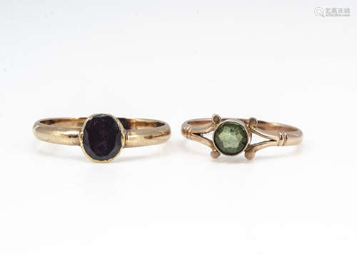 A peridot gold dress ring, marked 9ct, ring size K, and an early 19th Century garnet posey ring,