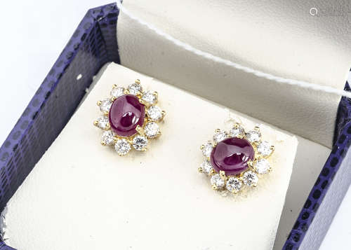 A pair of continental yellow metal ruby and diamond earrings, the cabochon rubies in four claw