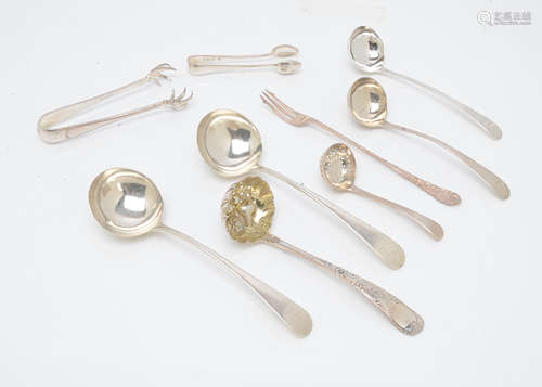 A group of Georgian and later silver serving spoons and items, including a pair of sauce ladles by