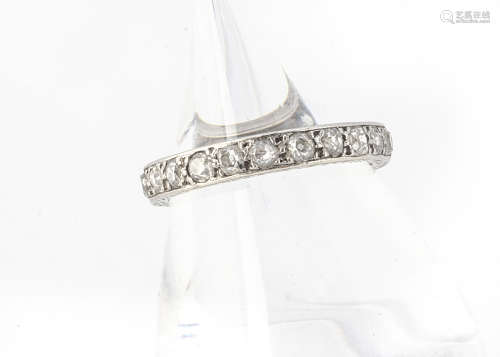 An Art Deco diamond and platinum full eternity band, the old cut diamonds in millegrain setting,