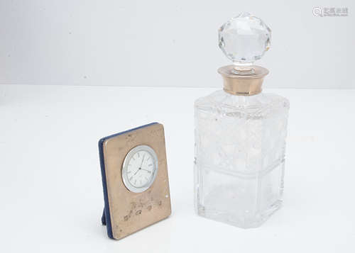 A modern glass and silver collared decanter, together with a modern silver fronted desk clock (2)