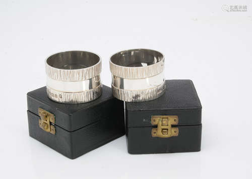 A pair of 1970s silver napkin rings by Gerald Benney, circular, 4.5cm diameter, with textured band