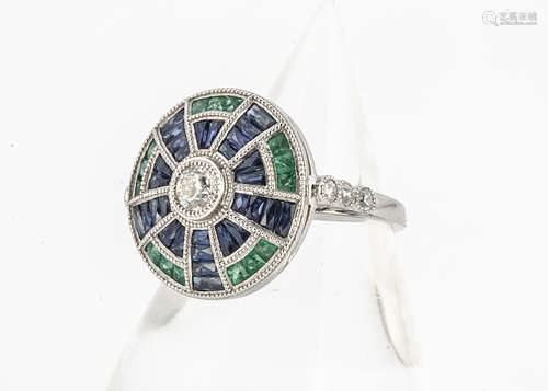 A platinum Art Deco style emerald, sapphire and diamond circular tablet ring, with old cut diamond