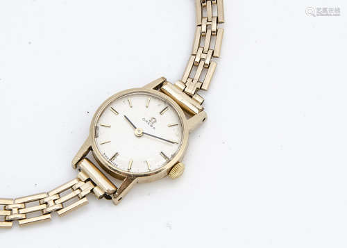 A c1960s Omega 9ct gold cased lady's wristwatch, 19mm, presented on a 9ct gold bracelet, 14.4g