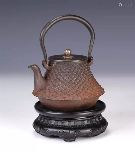 A CHINESE LONG HANDLE IRON KETTLE