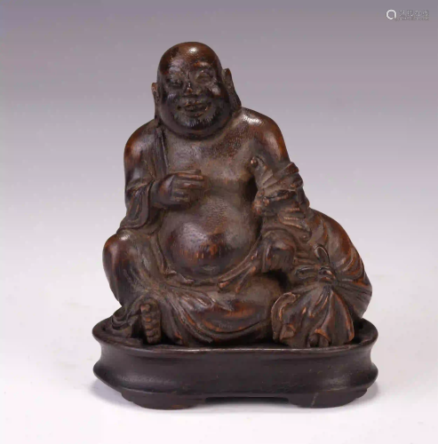 A CHINESE BAMBOO CARVING HOTEI SEATED STATUE