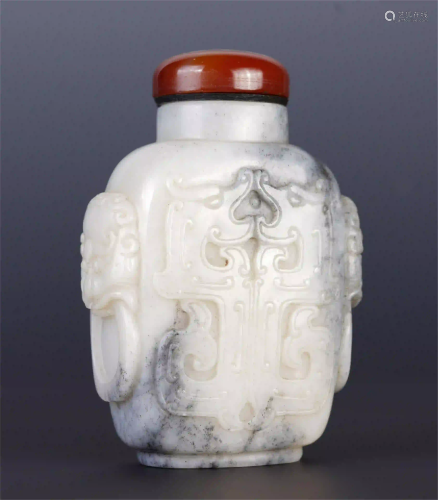 A CHINESE WHITE JADE SNUFF BOTTLE WITH RED COVER