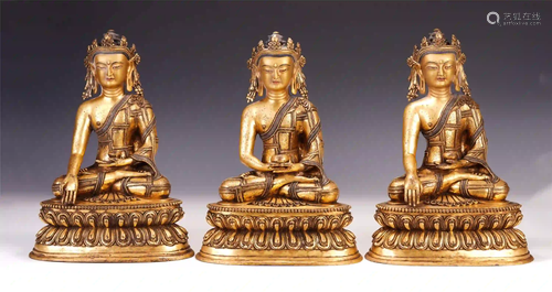 A SET OF CHINESE GILT BRONZE TRIKALEA BUDDHAS SEATED