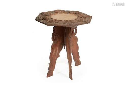 AN INDIAN OCTAGONAL CARVED WOOD FOLDING TABLE