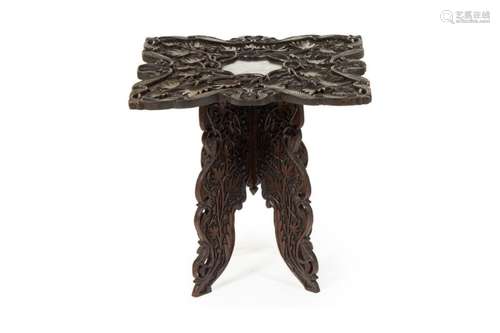 AN INDIAN CARVED FOLDING TABLE