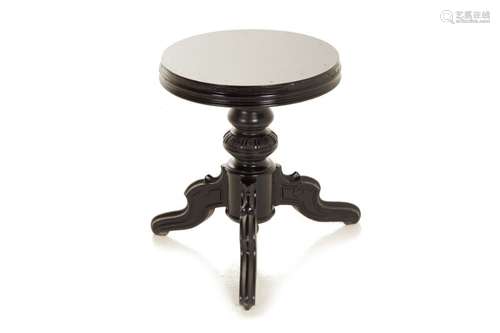 AN EBONISED LOW TRIPOD TABLE