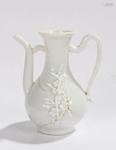 Chinese Dehua blanc de Chine wine jug, Kangxi period, with applied floral design, loped handle and