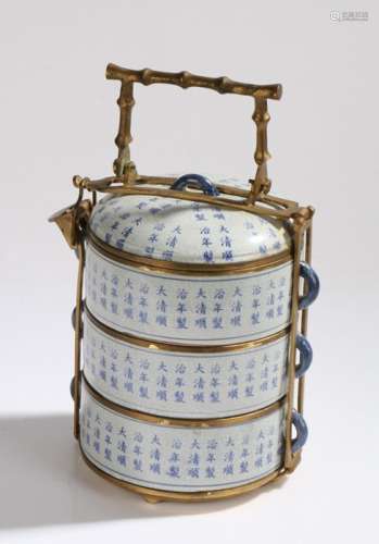 Set of three Chinese porcelain stacking pots, with Chinese character decoration, housed in a gilt