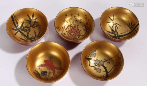 Set of five Japanese lacquered bowls, with bamboo, goldfish and blossom decoration to the