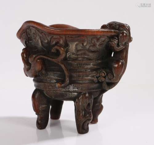 Libation cup with dragon decoration, raised on four scroll decorated legs,12cm high