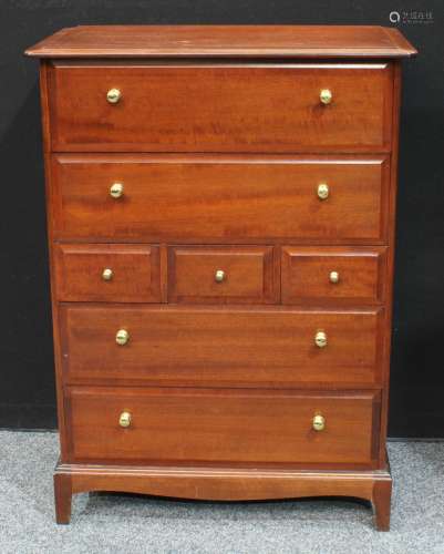 A Stag chest of drawers, oversailing rectangular top above an arrangement of drawers, shaped