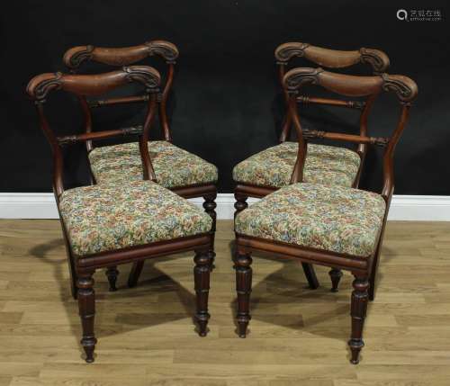 A set of four early Victorian mahogany dining chairs, cartouche shaped backs carved with scrolling