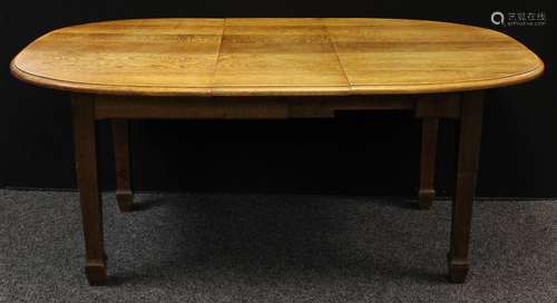 An Arts and Crafts oak extending dining table, oval top, tapered square legs, spade feet,