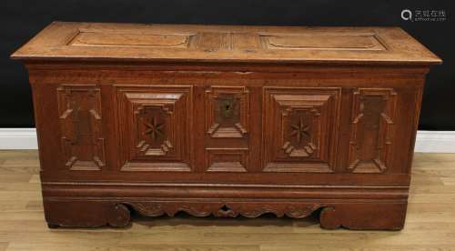 An 18th century North European oak blanket chest, hinged top with shaped raised panels, the front