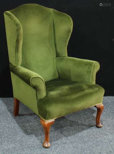 A George II style wing back arm chair, scroll arms, cabriole legs, pad feet, 119cm high.