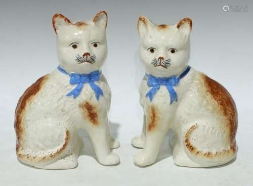 A pair of Staffordshire pottery cats, approx. 21cm high