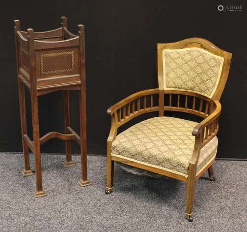 An Edwardian rosewood drawing room club arm-chair, shaped back, stuffed over upholstery, tapered