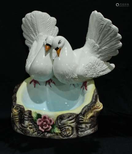 A large Capo-di-Monte model of love birds above a blue pool, 39cm high