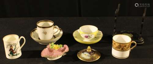 A late 19th century Miessen teacup and saucer, painted with cartouches of summer flowers within a