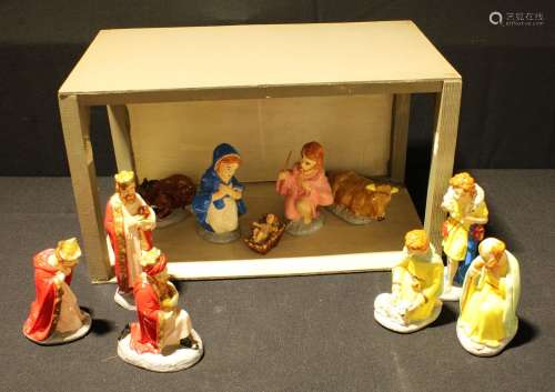 A mid 20th century Nativity scene comprising eleven painted plaster figures and scratch built stable