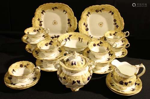 A 19th century Rockingham type tea set printed and painted with leafy scrolls in blue and ocher on a