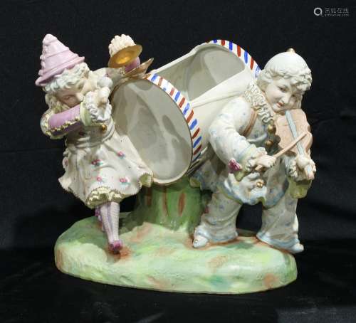 A 19th century style bisque table centre, musicians, he plays the violin, she the cymbals, 29.5cm